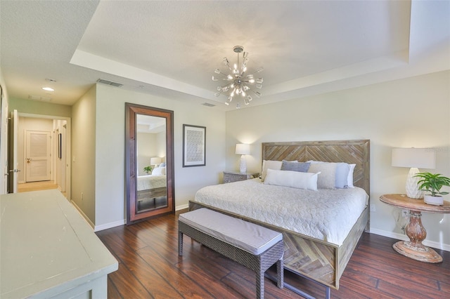 7344 Skybird Rd, Bradenton, FL 34209 - bedroom featuring a tray ceiling, a chandelier, and dark wood-type flooring