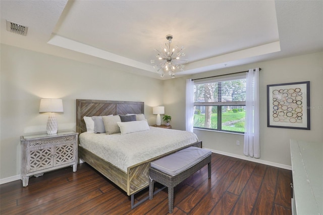 7344 Skybird Rd, Bradenton, FL 34209 - bedroom featuring a raised ceiling, a chandelier, and dark wood-style flooring