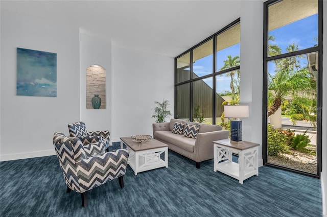 5855 Midnight Pass Rd Unit 416, Sarasota, FL 34242 - living area featuring dark colored carpet and floor to ceiling windows