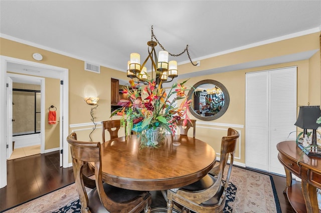 5855 Midnight Pass Rd Unit 416, Sarasota, FL 34242 - dining room with a chandelier, crown molding, and light wood finished floors