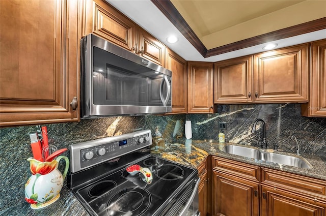 5855 Midnight Pass Rd Unit 416, Sarasota, FL 34242 - kitchen featuring stainless steel appliances, brown cabinetry, tasteful backsplash, and dark stone counters