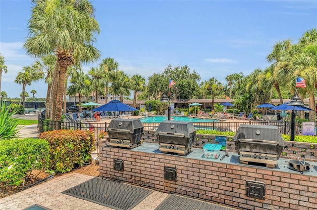 5855 Midnight Pass Rd Unit 416, Sarasota, FL 34242 - view of patio featuring a community pool and area for grilling