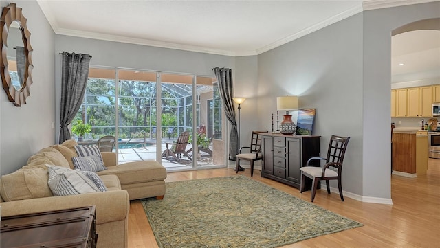 6206 Stillwater Ct, University Park, FL 34201 - living room with light wood-style floors, crown molding, and arched walkways