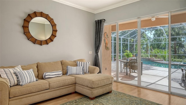 6206 Stillwater Ct, University Park, FL 34201 - living room featuring a sunroom, wood finished floors, and ornamental molding