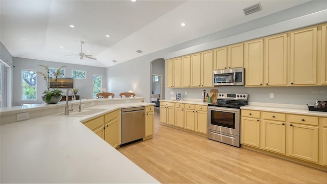 6206 Stillwater Ct, University Park, FL 34201 - kitchen featuring stainless steel appliances, arched walkways, light countertops, light wood finished floors, and recessed lighting