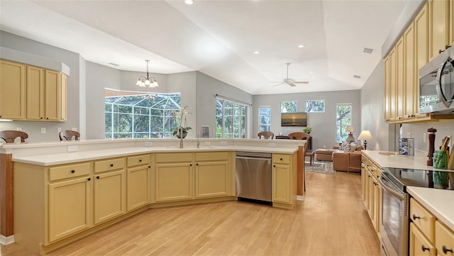 6206 Stillwater Ct, University Park, FL 34201 - kitchen with stainless steel appliances, open floor plan, light wood-type flooring, light countertops, and recessed lighting