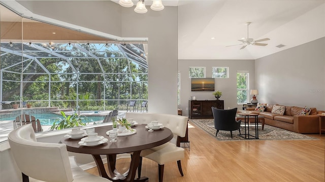 6206 Stillwater Ct, University Park, FL 34201 - dining room featuring a sunroom, ceiling fan, light wood-style floors, and lofted ceiling