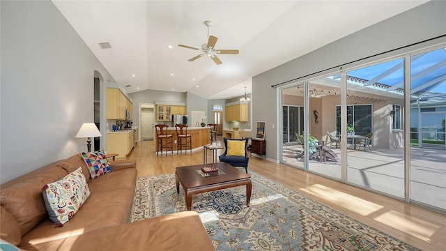 6206 Stillwater Ct, University Park, FL 34201 - living room featuring light wood-style flooring, lofted ceiling, ceiling fan, and arched walkways