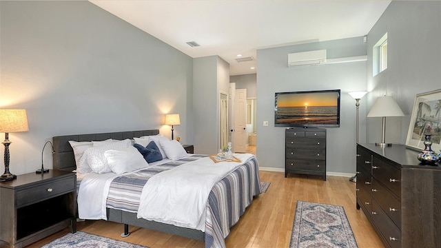 6206 Stillwater Ct, University Park, FL 34201 - bedroom with a wall mounted AC and light wood-style flooring