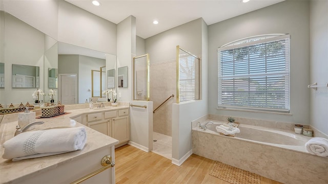 6206 Stillwater Ct, University Park, FL 34201 - bathroom featuring a garden tub, vanity, walk in shower, wood finished floors, and recessed lighting
