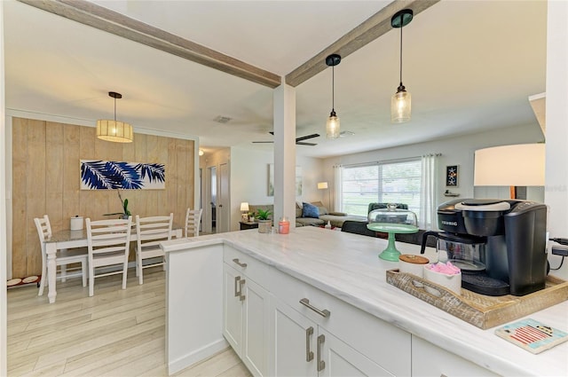 237 Saxon Cir, Venice, FL 34293 - kitchen with light wood-style floors, open floor plan, white cabinetry, light stone countertops, and pendant lighting