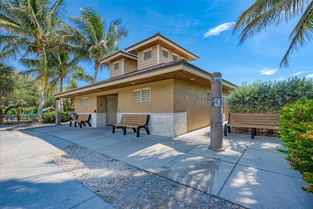237 Saxon Cir, Venice, FL 34293 - view of front facade with a patio and stucco siding