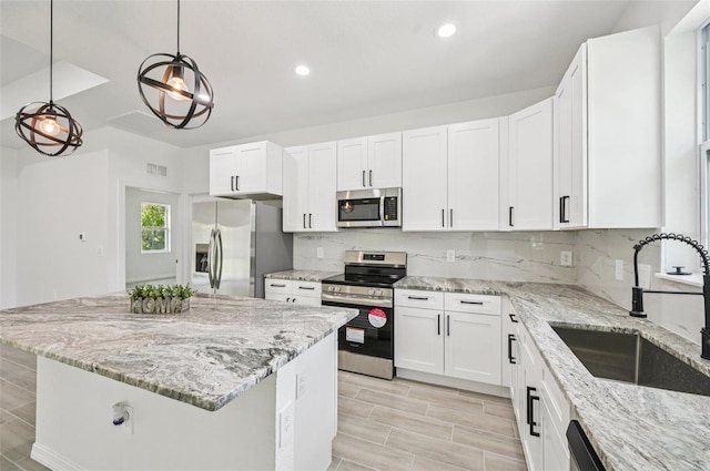 2523 Hagerick Ln, North Port, FL 34288 - kitchen with appliances with stainless steel finishes, white cabinetry, tasteful backsplash, and recessed lighting