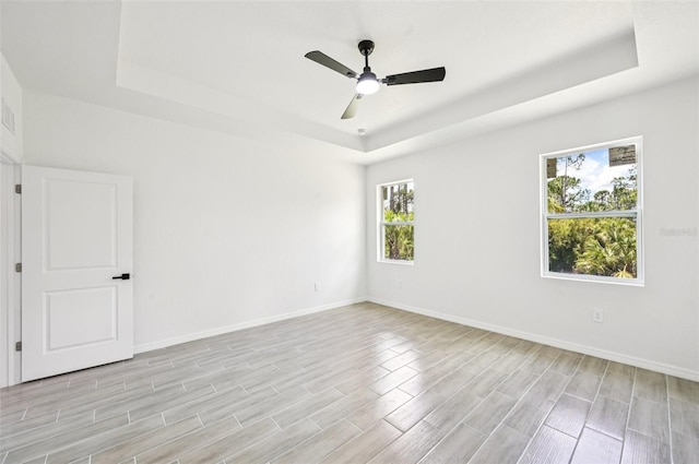 2523 Hagerick Ln, North Port, FL 34288 - unfurnished room featuring a raised ceiling, light wood-style floors, and a ceiling fan
