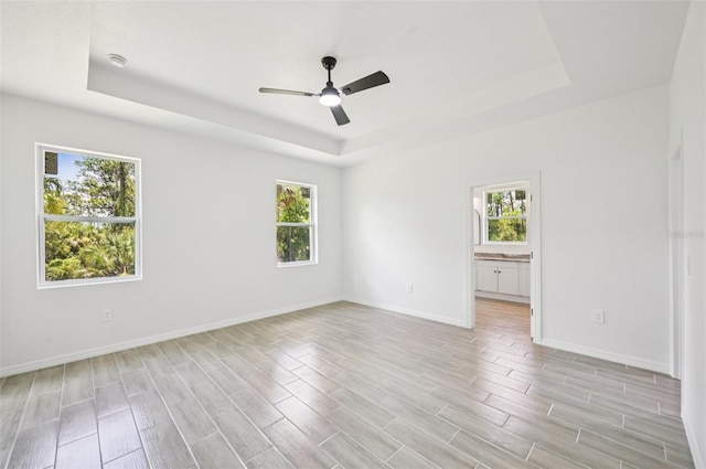 2523 Hagerick Ln, North Port, FL 34288 - empty room featuring a raised ceiling, light wood-type flooring, ceiling fan, and a smoke detector