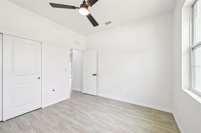 2523 Hagerick Ln, North Port, FL 34288 - unfurnished bedroom with a closet, light wood-type flooring, and a ceiling fan