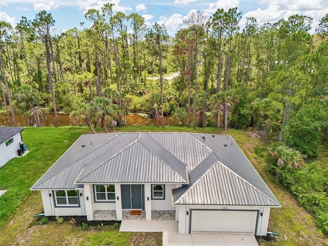 2523 Hagerick Ln, North Port, FL 34288 - view of front facade featuring a front yard, an attached garage, driveway, stucco siding, and stone siding
