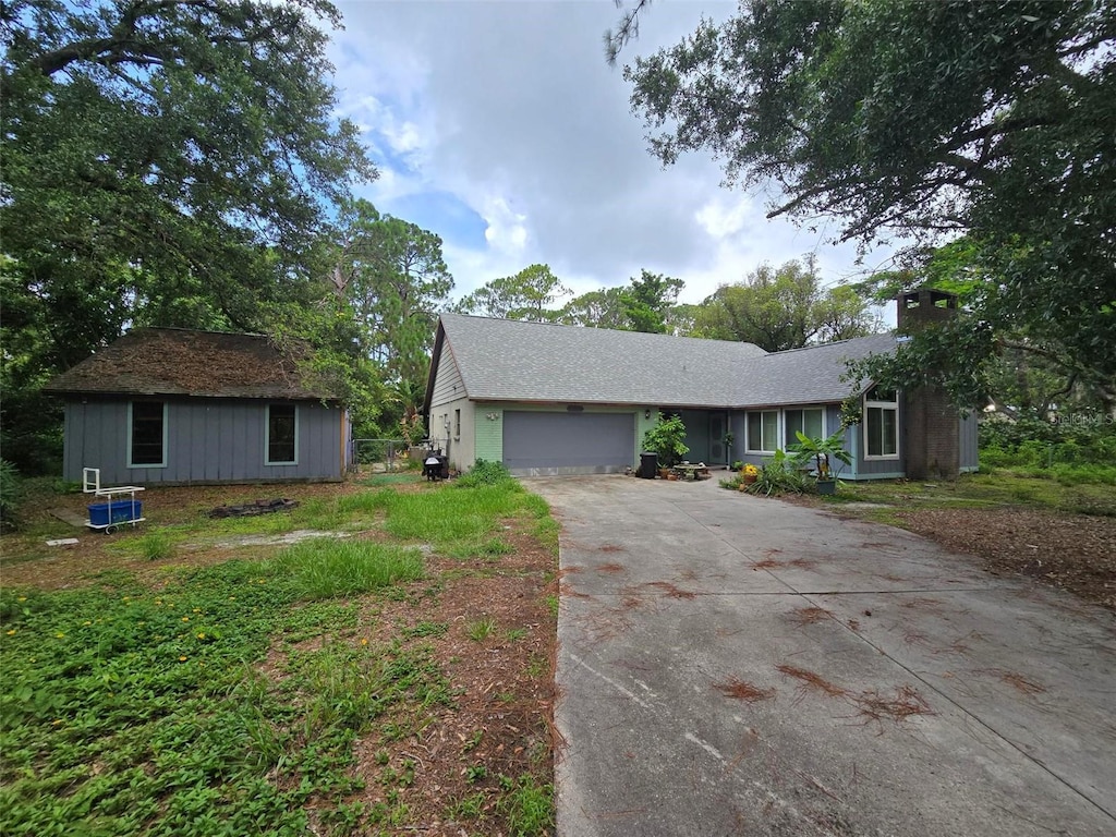 4607 Mink Rd, Sarasota, FL 34235 - ranch-style home with driveway, a garage, and a chimney