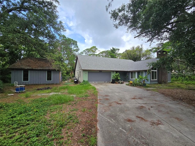 4607 Mink Rd, Sarasota, FL 34235 - ranch-style home with driveway, a garage, and a chimney
