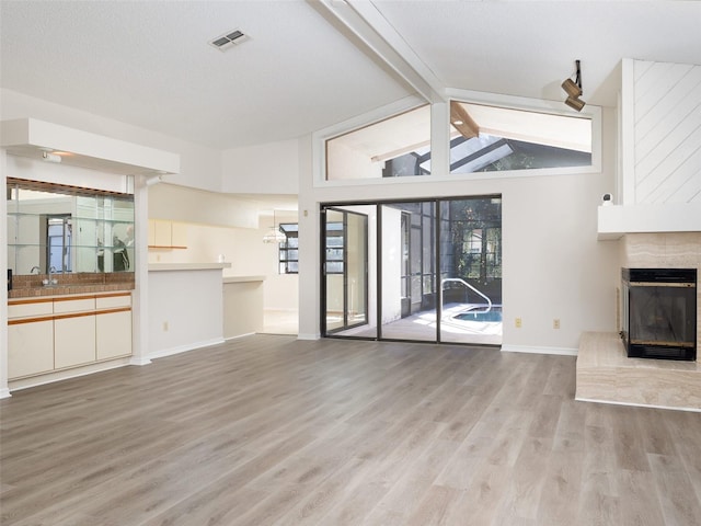 8260 Berkeley Manor Blvd, Spring Hill, FL 34606 - unfurnished living room featuring a fireplace and wood finished floors
