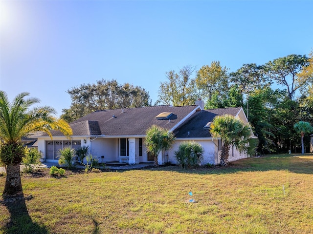 8260 Berkeley Manor Blvd, Spring Hill, FL 34606 - ranch-style house featuring a front lawn, a garage, stucco siding, and a chimney