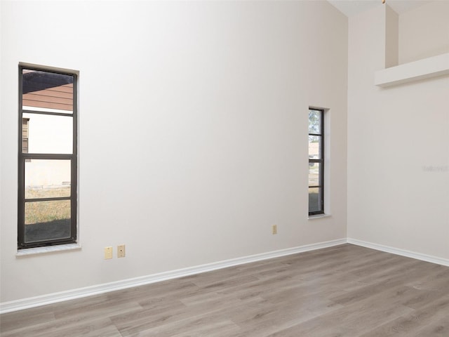 8260 Berkeley Manor Blvd, Spring Hill, FL 34606 - spare room featuring light wood-type flooring and a high ceiling