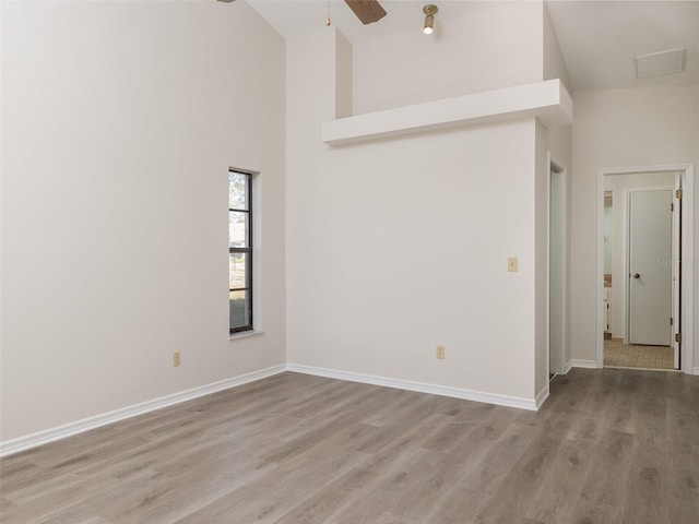 8260 Berkeley Manor Blvd, Spring Hill, FL 34606 - empty room with ceiling fan, wood finished floors, and a towering ceiling
