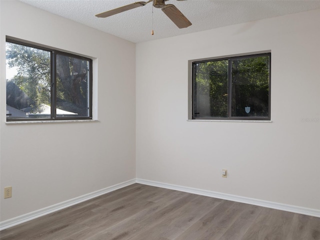 8260 Berkeley Manor Blvd, Spring Hill, FL 34606 - empty room featuring wood finished floors, a ceiling fan, and a textured ceiling