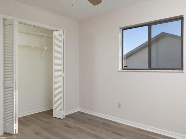 8260 Berkeley Manor Blvd, Spring Hill, FL 34606 - unfurnished bedroom featuring wood finished floors, a closet, and a textured ceiling