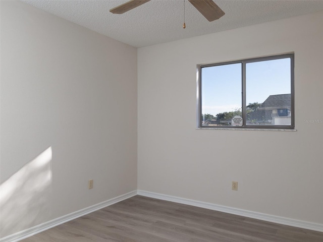 8260 Berkeley Manor Blvd, Spring Hill, FL 34606 - spare room with wood finished floors, ceiling fan, and a textured ceiling