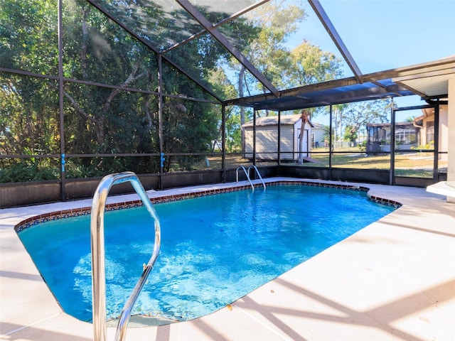 8260 Berkeley Manor Blvd, Spring Hill, FL 34606 - outdoor pool with glass enclosure, a storage shed, and a patio