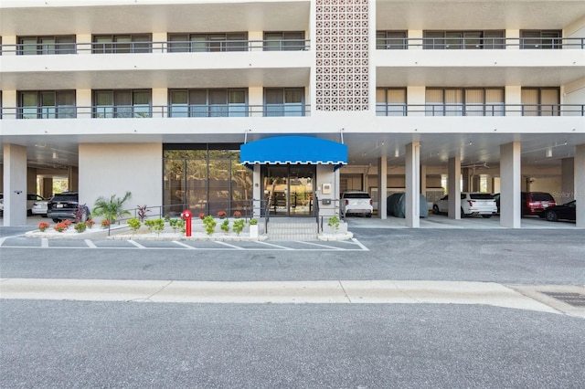 6415 Midnight Pass Rd Unit 502, Sarasota, FL 34242 - property entrance with covered parking and stucco siding