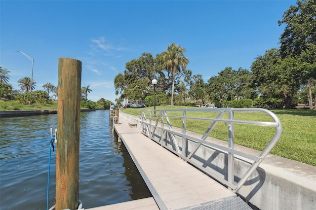 6415 Midnight Pass Rd Unit 502, Sarasota, FL 34242 - dock area with a water view and a lawn