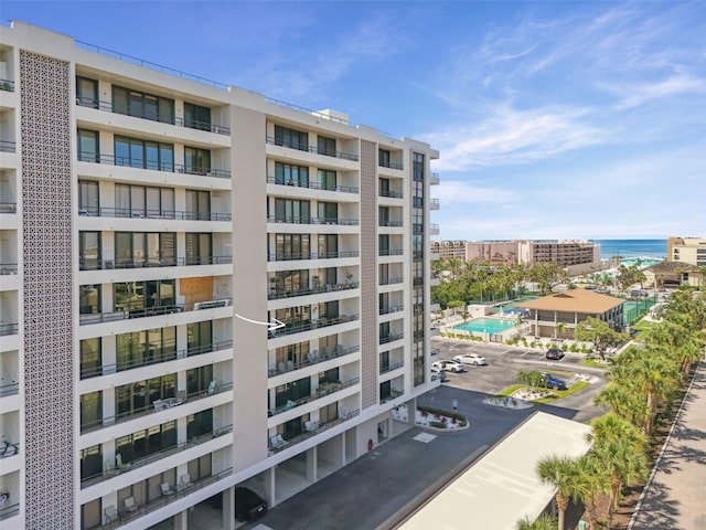 6415 Midnight Pass Rd Unit 502, Sarasota, FL 34242 - view of apartment building / complex featuring uncovered parking and a water view