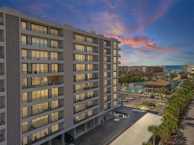 6415 Midnight Pass Rd Unit 502, Sarasota, FL 34242 - property at dusk featuring a view of apartment building / complex and uncovered parking
