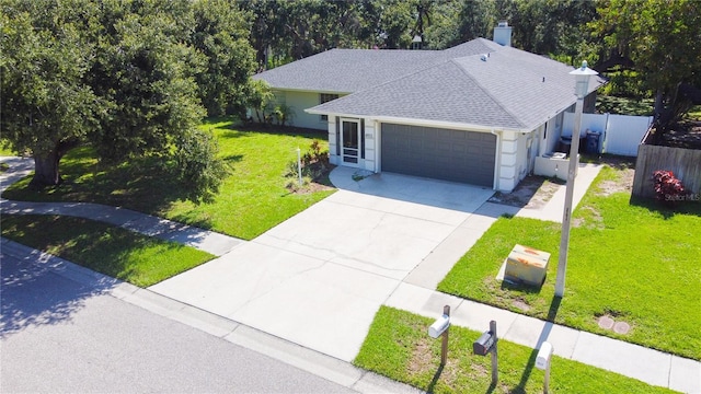 4913 32nd St E, Bradenton, FL 34203 - ranch-style home featuring a garage, a shingled roof, driveway, and a chimney