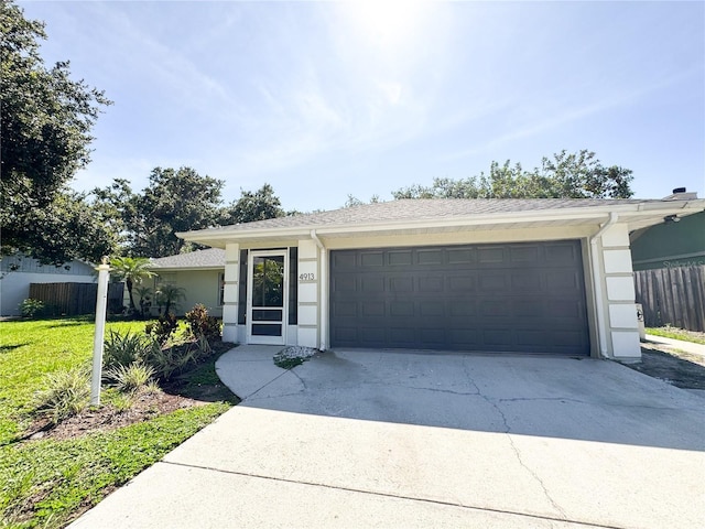 4913 32nd St E, Bradenton, FL 34203 - ranch-style house with concrete driveway, stucco siding, and an attached garage