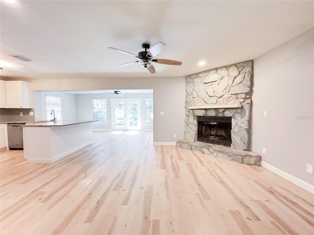 4913 32nd St E, Bradenton, FL 34203 - unfurnished living room with ceiling fan, light wood-type flooring, a fireplace, and recessed lighting