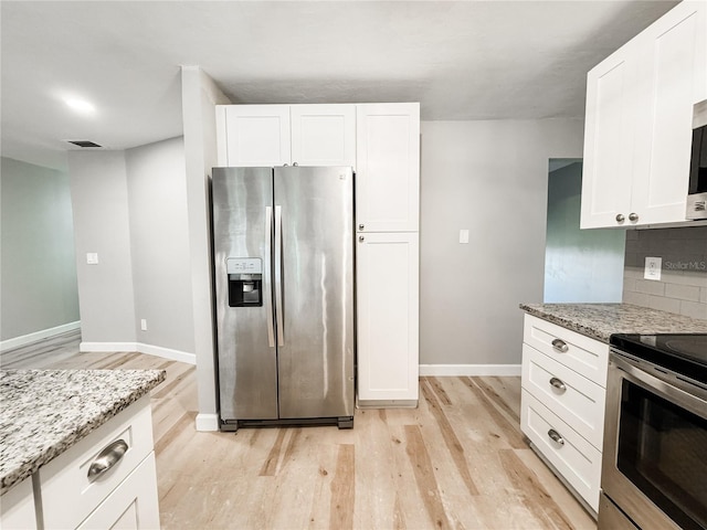 4913 32nd St E, Bradenton, FL 34203 - kitchen with appliances with stainless steel finishes, light wood-style flooring, light stone countertops, and white cabinets