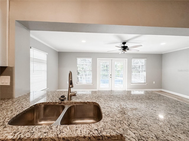 4913 32nd St E, Bradenton, FL 34203 - kitchen with crown molding, light stone countertops, a ceiling fan, recessed lighting, and open floor plan