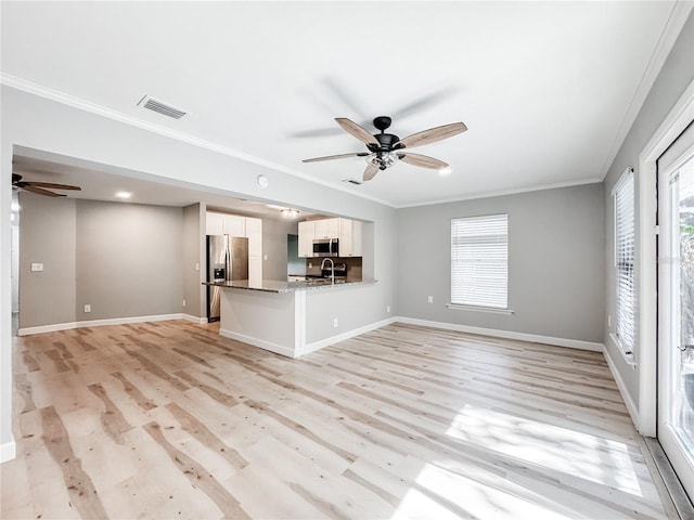 4913 32nd St E, Bradenton, FL 34203 - unfurnished living room featuring a ceiling fan, light wood finished floors, and crown molding