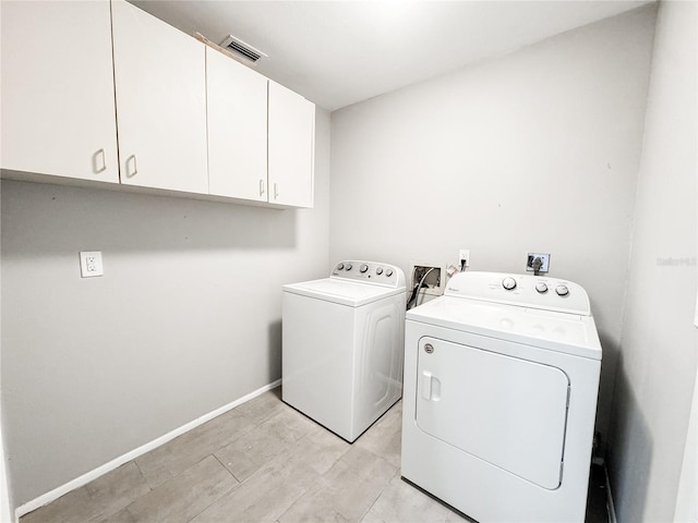 4913 32nd St E, Bradenton, FL 34203 - laundry area with washing machine and clothes dryer and cabinet space