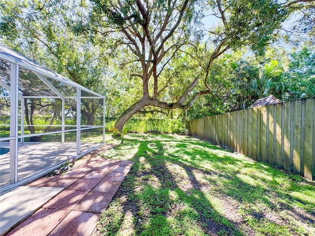 4913 32nd St E, Bradenton, FL 34203 - view of yard featuring a patio area and glass enclosure