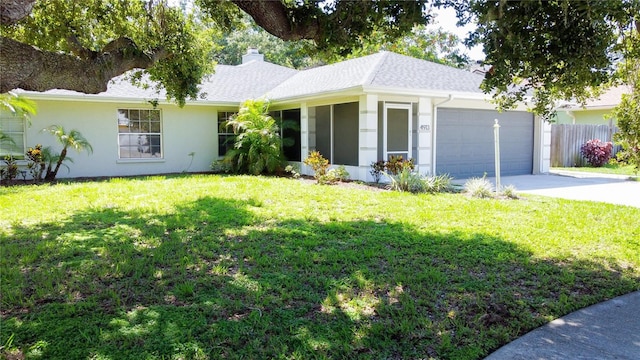4913 32nd St E, Bradenton, FL 34203 - ranch-style house with an attached garage, a chimney, driveway, stucco siding, and a sunroom