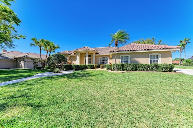 8315 Eagle Xing, Sarasota, FL 34241 - mediterranean / spanish house featuring stucco siding, a front lawn, and a tiled roof