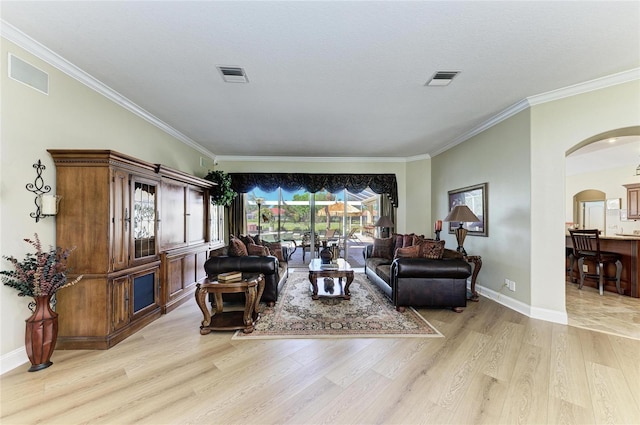 8315 Eagle Xing, Sarasota, FL 34241 - living area with arched walkways, light wood-style flooring, and crown molding