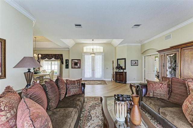 8315 Eagle Xing, Sarasota, FL 34241 - living area featuring light wood-style flooring, lofted ceiling, ornamental molding, and arched walkways
