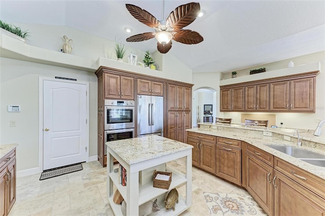 8315 Eagle Xing, Sarasota, FL 34241 - kitchen with stainless steel appliances, open shelves, arched walkways, vaulted ceiling, and light stone countertops