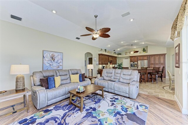 8315 Eagle Xing, Sarasota, FL 34241 - living room featuring ceiling fan, arched walkways, lofted ceiling, light wood-style floors, and recessed lighting