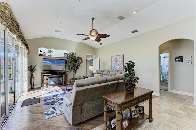 8315 Eagle Xing, Sarasota, FL 34241 - living room with arched walkways, ceiling fan, a glass covered fireplace, vaulted ceiling, and recessed lighting